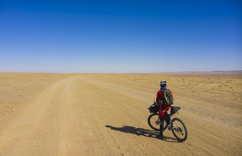 Omar Di Felice on a gravel bike in the Gobi Desert tracks. Following in the footsteps of Marco Polo, Jules Verne and Roald Amudsen.